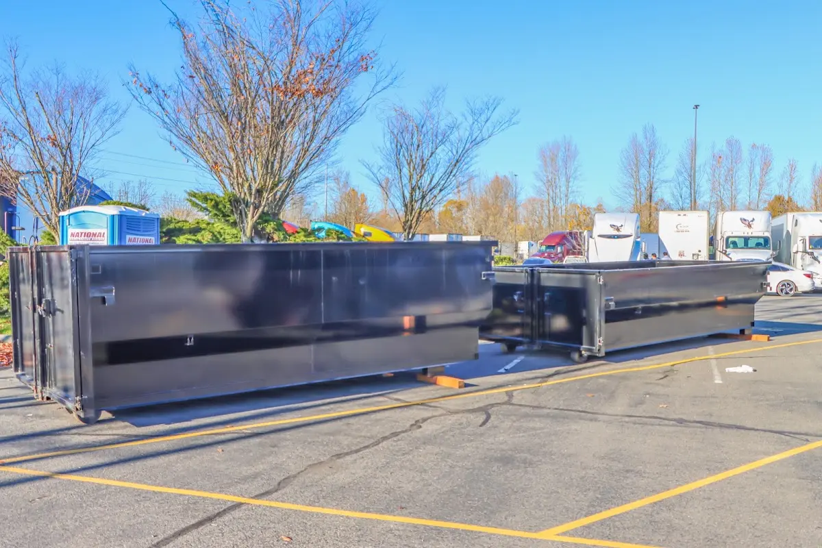 Professional dumpster rental service with roll-off container on residential driveway in Suncrest